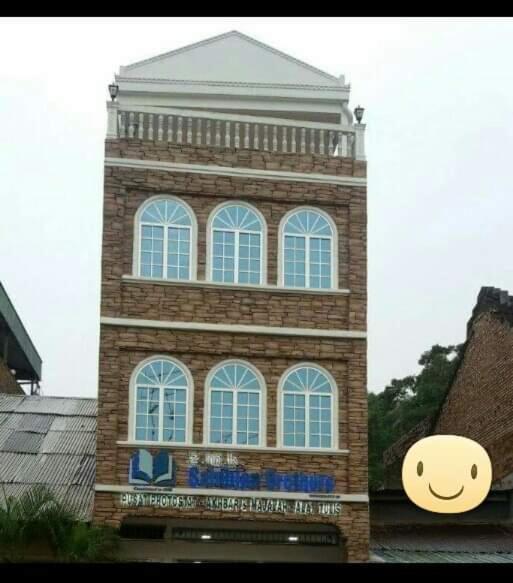a tall brick building with a smiley face on it at ZMK STAY 
