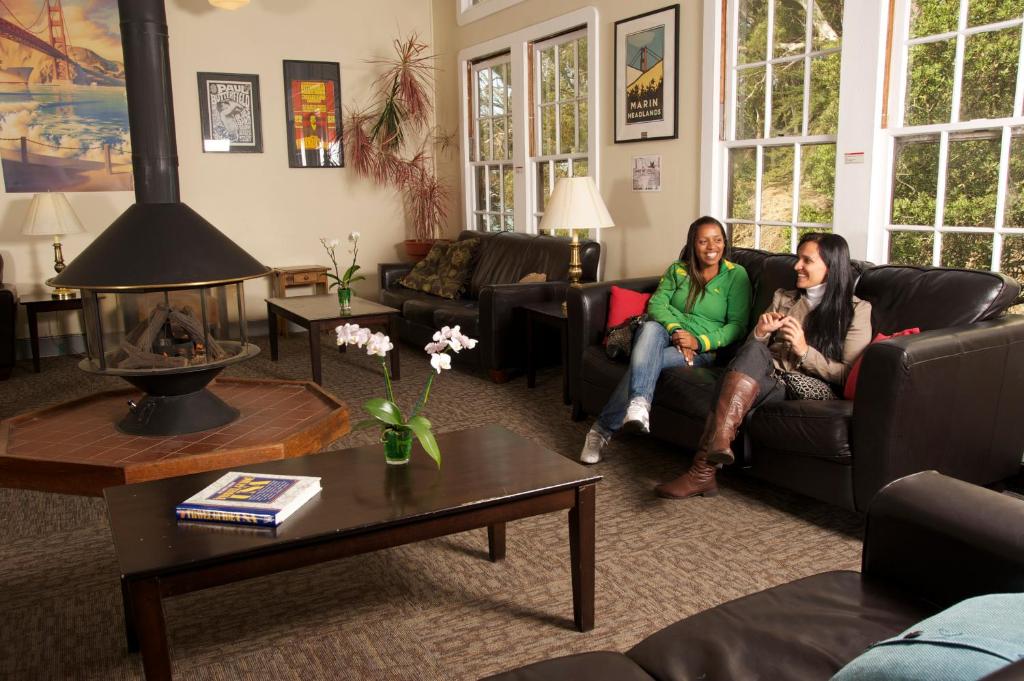 two women sitting on a couch in a living room at HI San Francisco Fisherman's Wharf Hostel in San Francisco