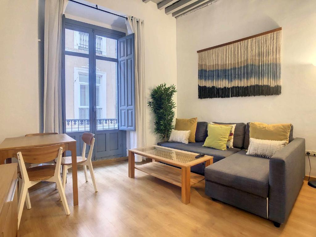 a living room with a couch and a table at Apartamento centro de malaga in Málaga