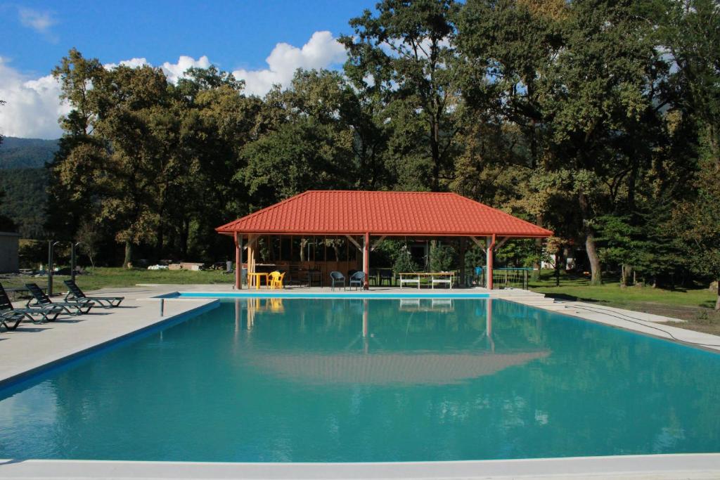 a swimming pool with a gazebo in a park at Kvareli Oaks in Kvareli