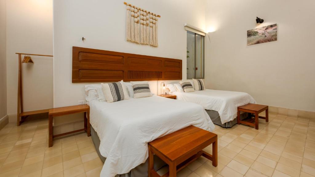 Postel nebo postele na pokoji v ubytování Villa Orquídea Boutique Hotel