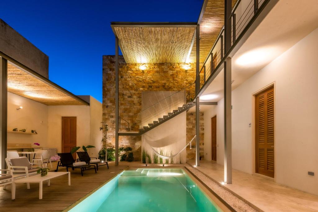 an indoor swimming pool in a house at Villa Orquídea Boutique Hotel in Mérida