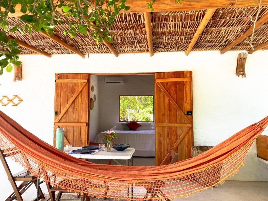 a hammock in the courtyard of a house at Casa da Mata Corumbau in Corumbau