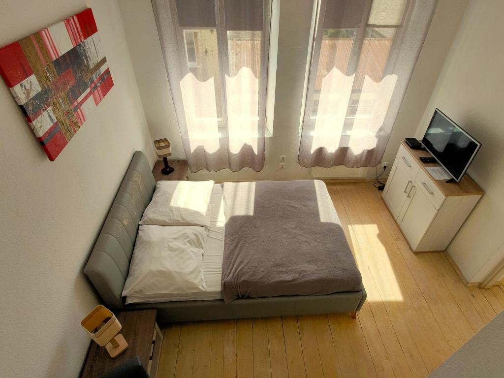 een kleine slaapkamer met een bed en een televisie bij Kazimierz/Old Town Apartment in Krakau