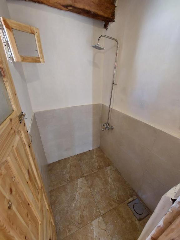 a small bathroom with a shower in the corner at Forest Camp Siwa - كامب الغابة in Siwa