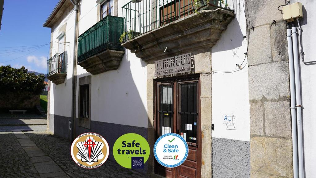 a building with signs on the side of it at Albergue Santiago de Caminha in Caminha