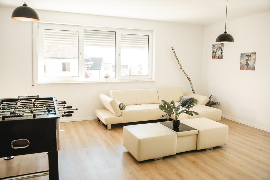 a living room with a couch and a table at Shine Apartment Wackersdorf I in Wackersdorf