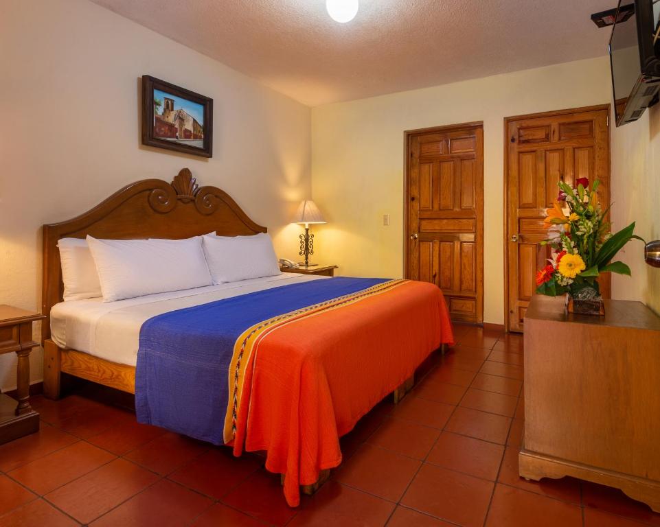 Postel nebo postele na pokoji v ubytování Hotel la Parroquia