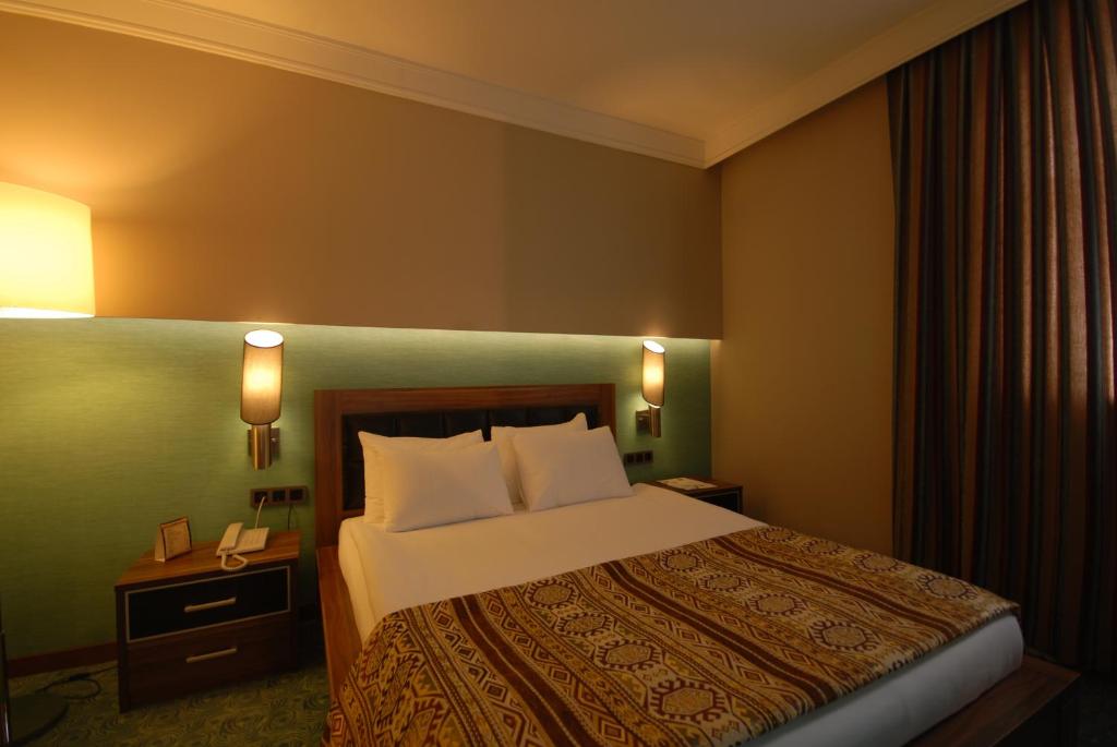 A bed or beds in a room at Suhan Cappadocia Hotel & Spa