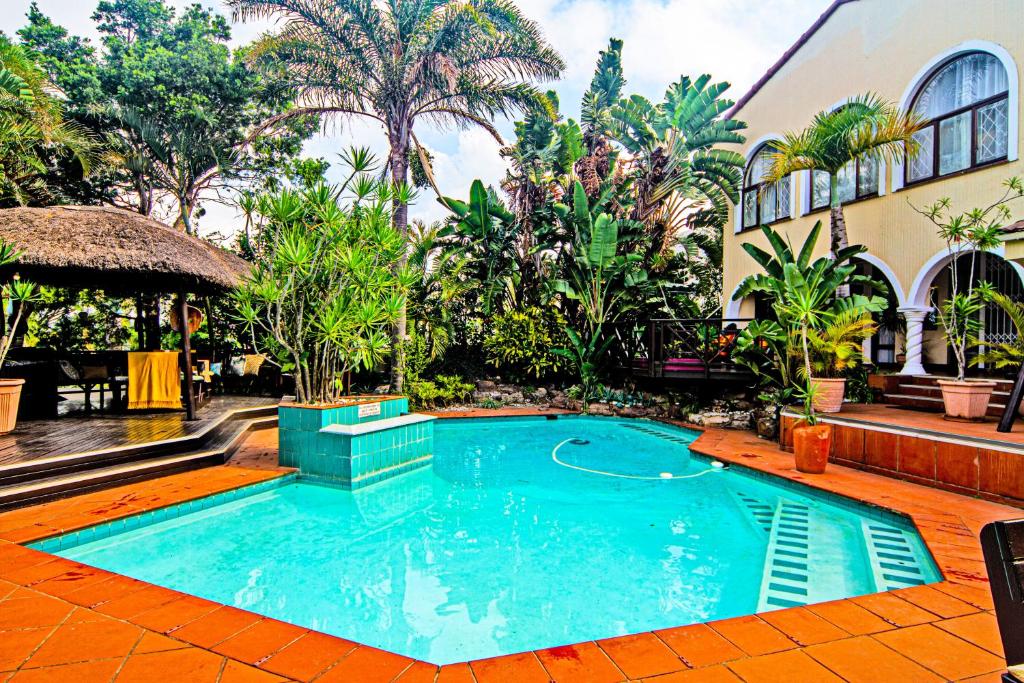 a swimming pool in the middle of a resort at La Loggia Bed and Breakfast in Durban