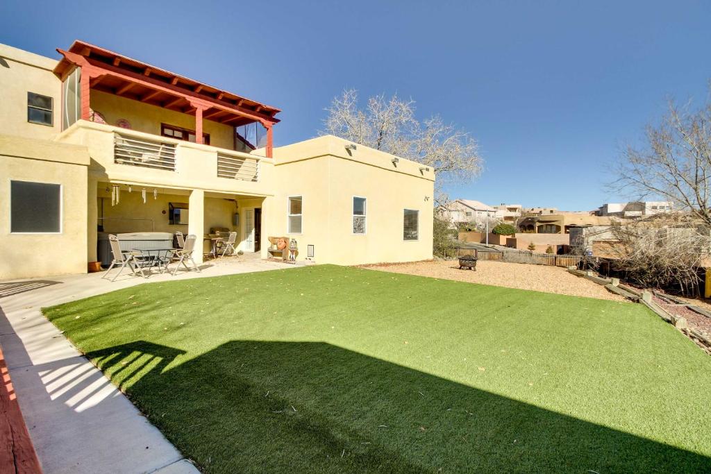 a yard with a large lawn in front of a house at Albuquerque Home with Spacious Yard and Fire Pit! in Albuquerque