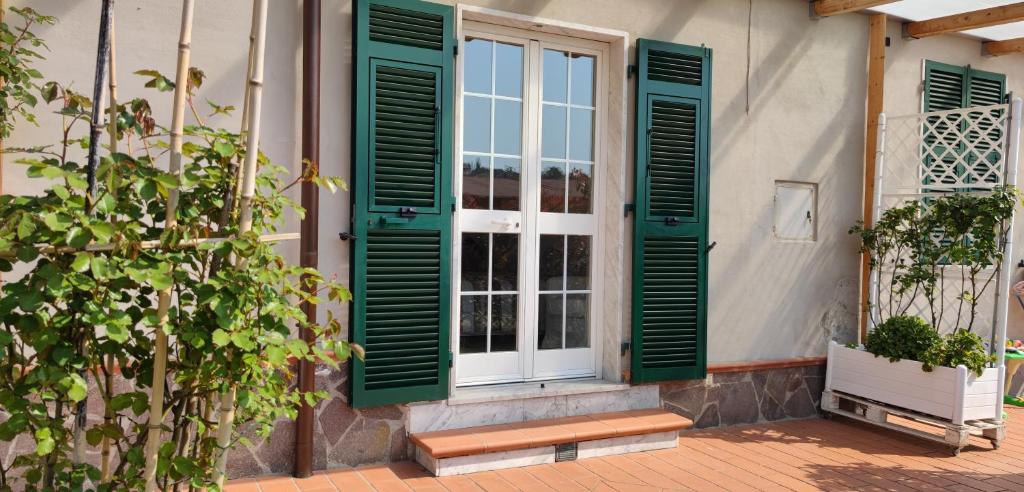 una ventana con persianas verdes en una casa en Rosi Room en Giucano