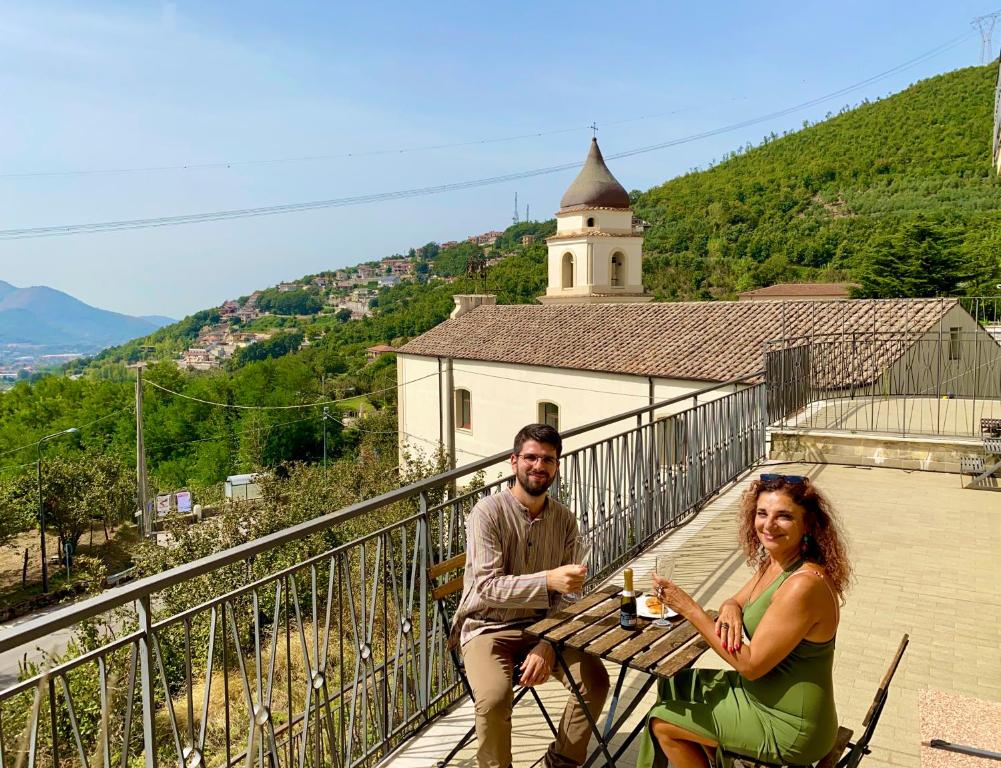 un homme et une femme assis à une table de pique-nique dans l'établissement Casa Lia, à Fisciano