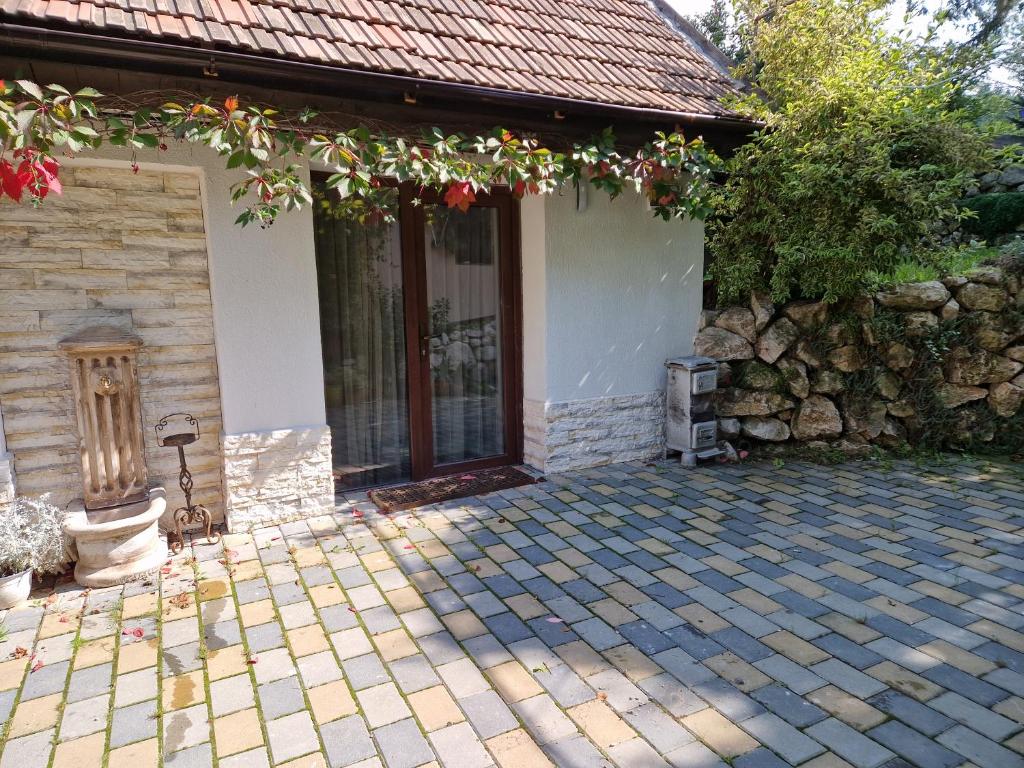 a house with a stone wall and a patio at Bran Studio in Bran