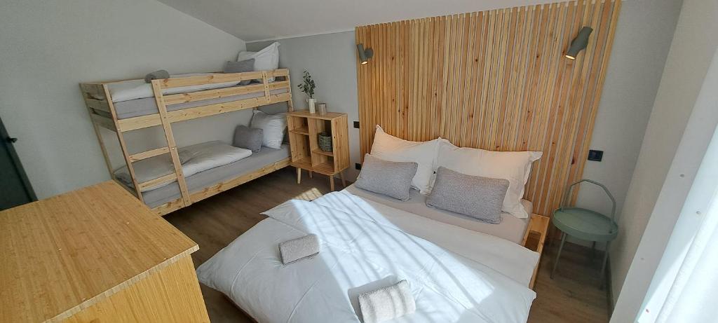 a bedroom with two bunk beds and a desk at Apartmány Staroměstská romance in Staré Město