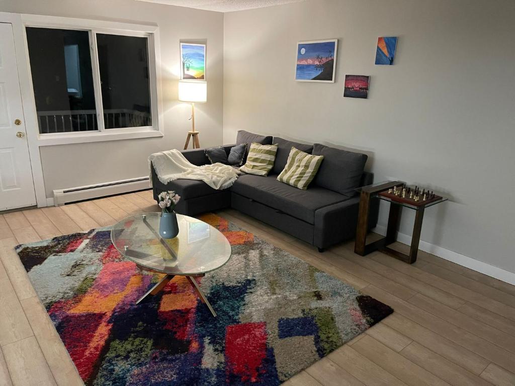 a living room with a couch and a glass table at Perfect Stays in Edmonton