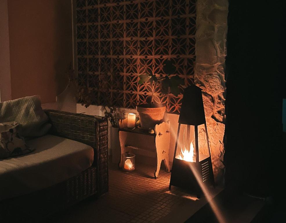a room with a bed and a cat standing next to a lamp at Quinta Amarela - B&B in Nazaré