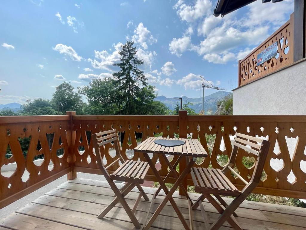 a patio with two chairs and a table on a balcony at Chalet Crest-Voland, 2 pièces, 4 personnes - FR-1-505-186 in Crest-Voland