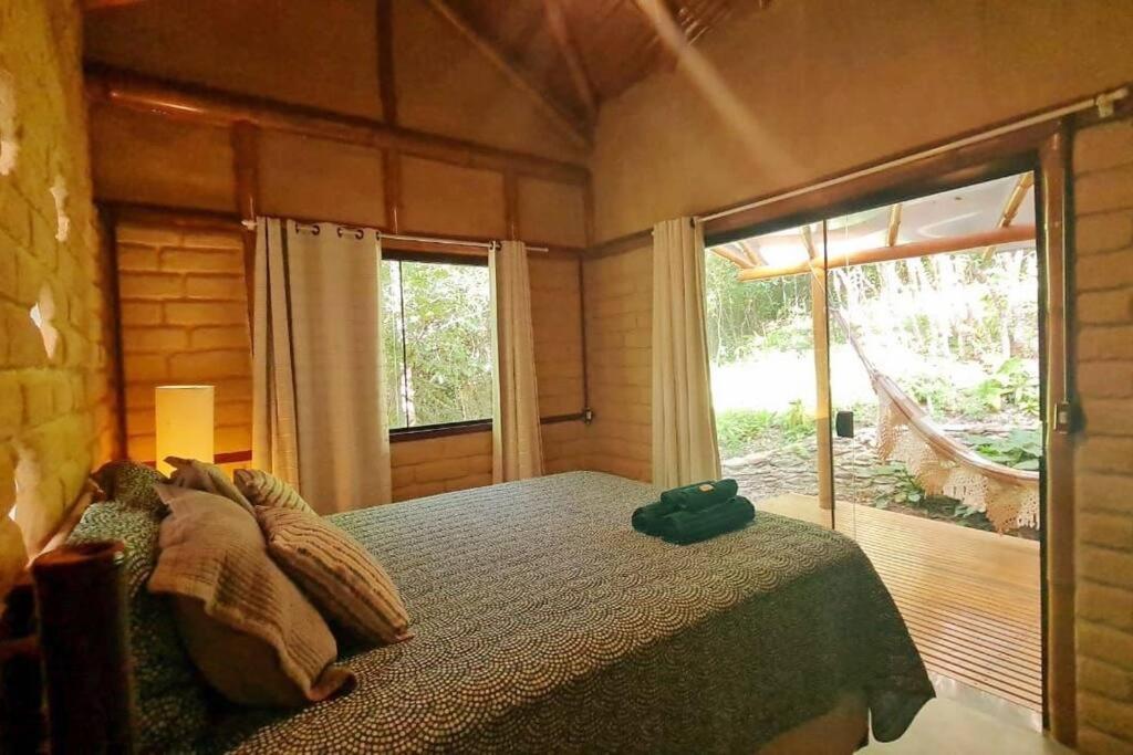 A bed or beds in a room at Casa Libélula! Refúgio com excelente Wi-Fi /Dragonfly House! Nature retreat with great wifi