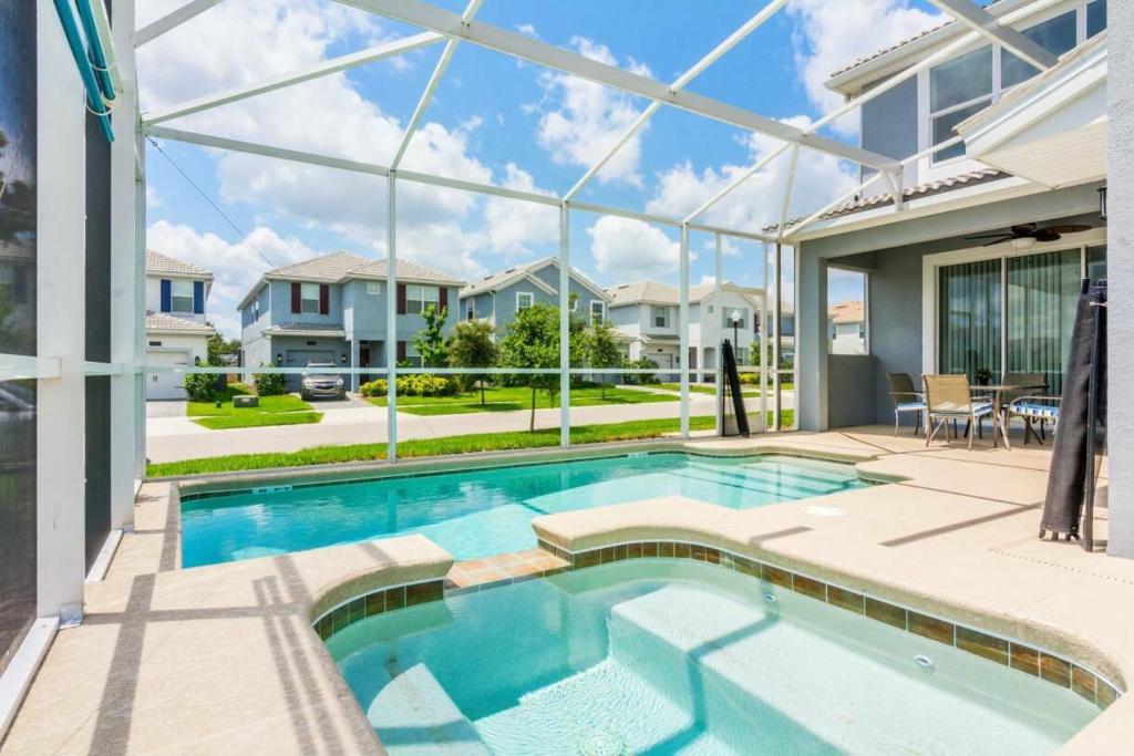 a swimming pool in the middle of a house at Modern Vacation Home with Private Pool CG1593 in Davenport