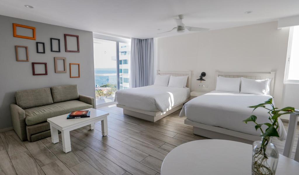 Postel nebo postele na pokoji v ubytování Oleo Cancun Playa All Inclusive Resort
