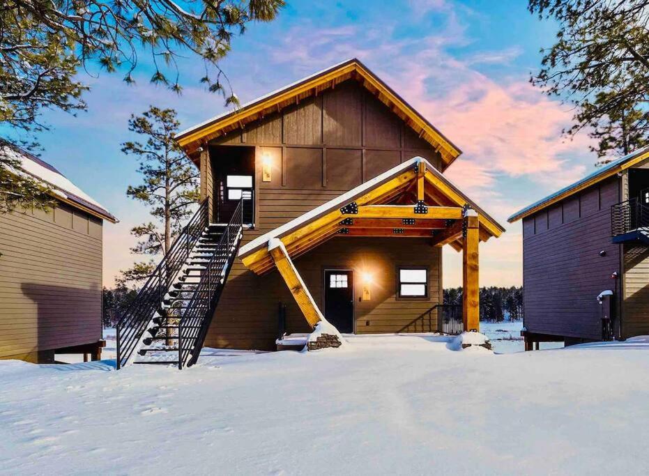 a building with a staircase in the snow at Luxurious Mountain Retreat! in Show Low