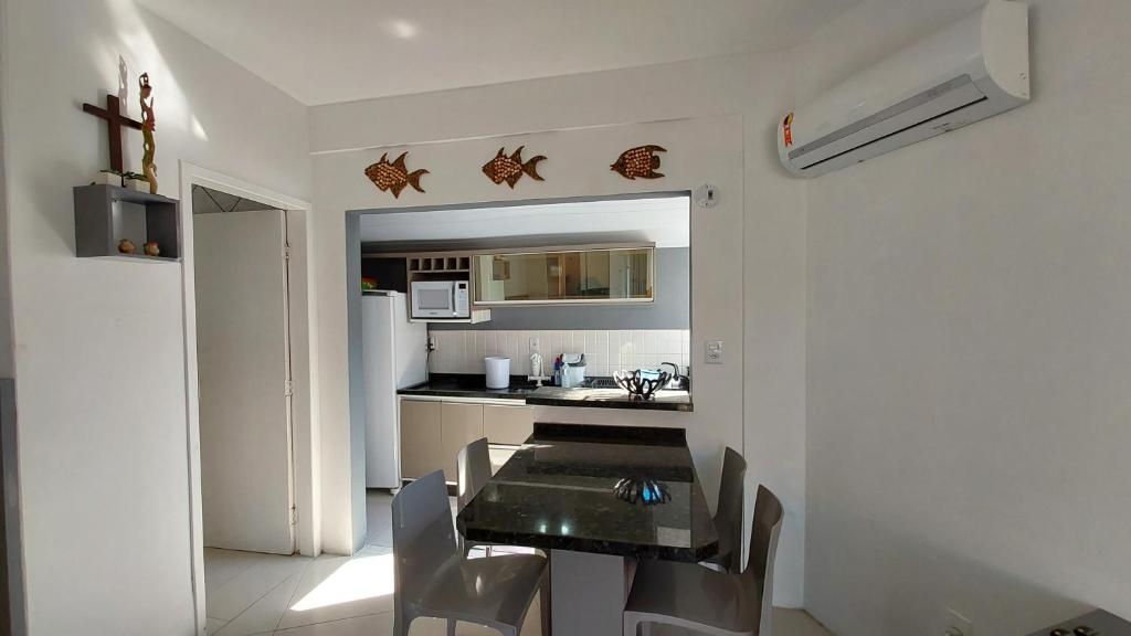 - une cuisine avec une table et des chaises dans la chambre dans l'établissement Apartamento térreo, à Florianópolis