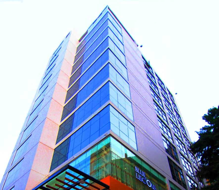 a tall building with a lot of glass windows at Bengal Blueberry in Dhaka