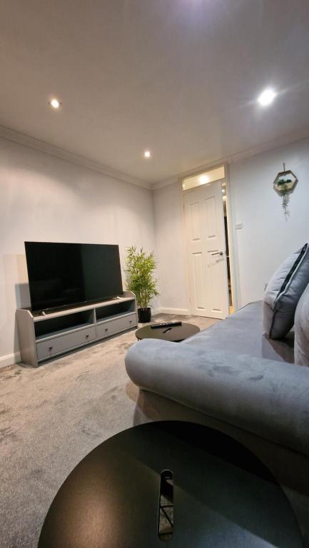 a living room with a flat screen tv and a couch at London City Stay in London