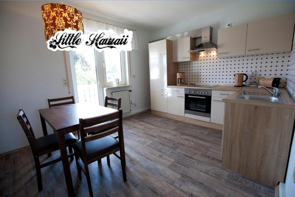 a kitchen and dining room with a table and a sink at Little Hawaii & Texas in Bad Wildungen