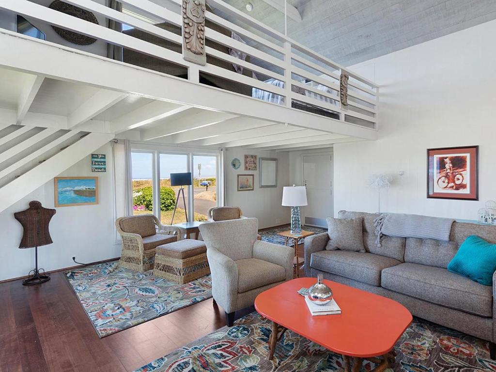 a living room with a couch and a table at Seaside Cove Vue in Seaside