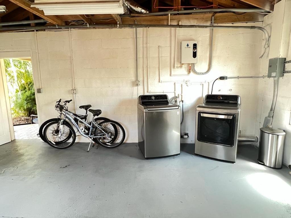 a bike parked in a garage with two trash cans at Hostal Sky Crest in Clearwater