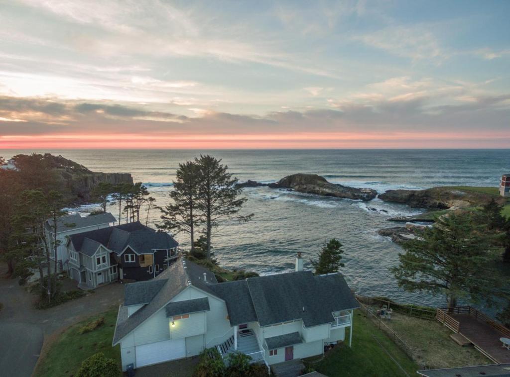 an aerial view of a house and the ocean at Pirate's Cove in Depoe Bay