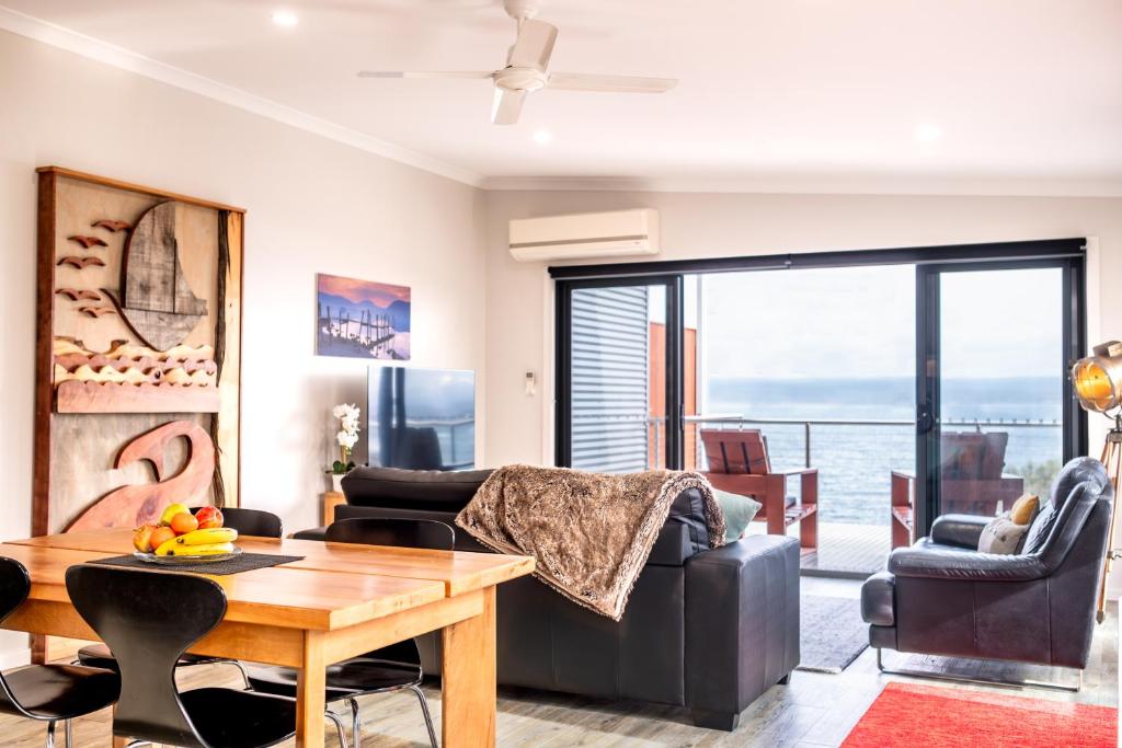 a living room with a couch and a table at Whale Watcher 2 in Coles Bay