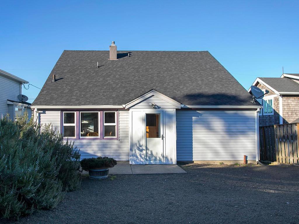 a small white house with a garage at Jim's House in Seaside