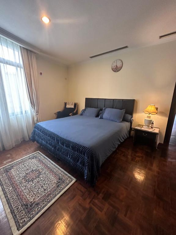 a bedroom with a large bed and a rug at apartemen in Jakarta