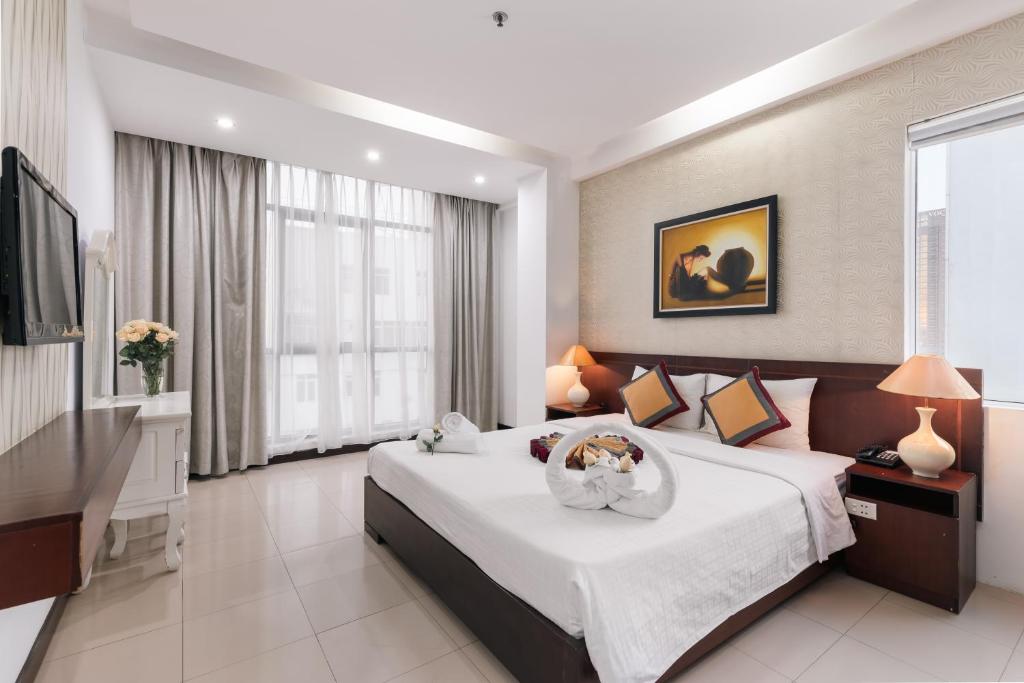 a bedroom with a large bed and a television at Star Hotel and Spa Danang in Danang
