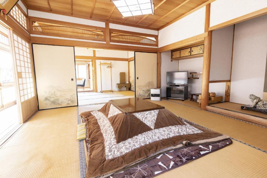 a large room with a bed and a tv at Ichimaru Ryokan - Vacation STAY 77709v in Tenkawa