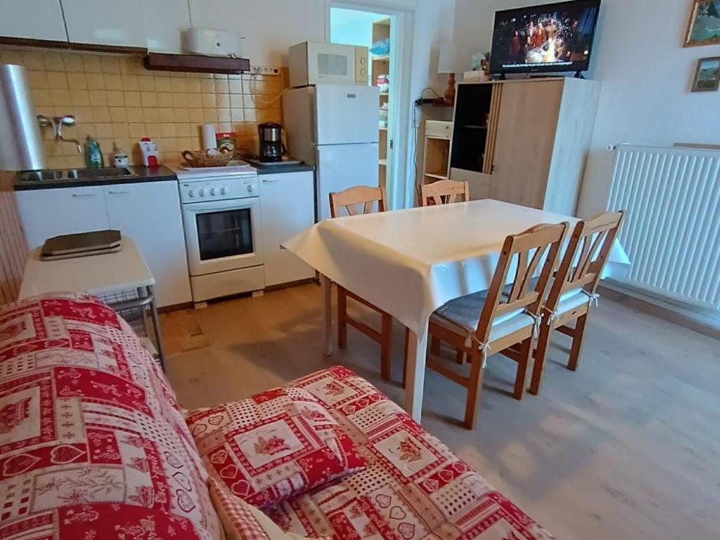a kitchen with a table and a couch in a room at Appartement Briançon, 2 pièces, 4 personnes - FR-1-762-8 in Briançon