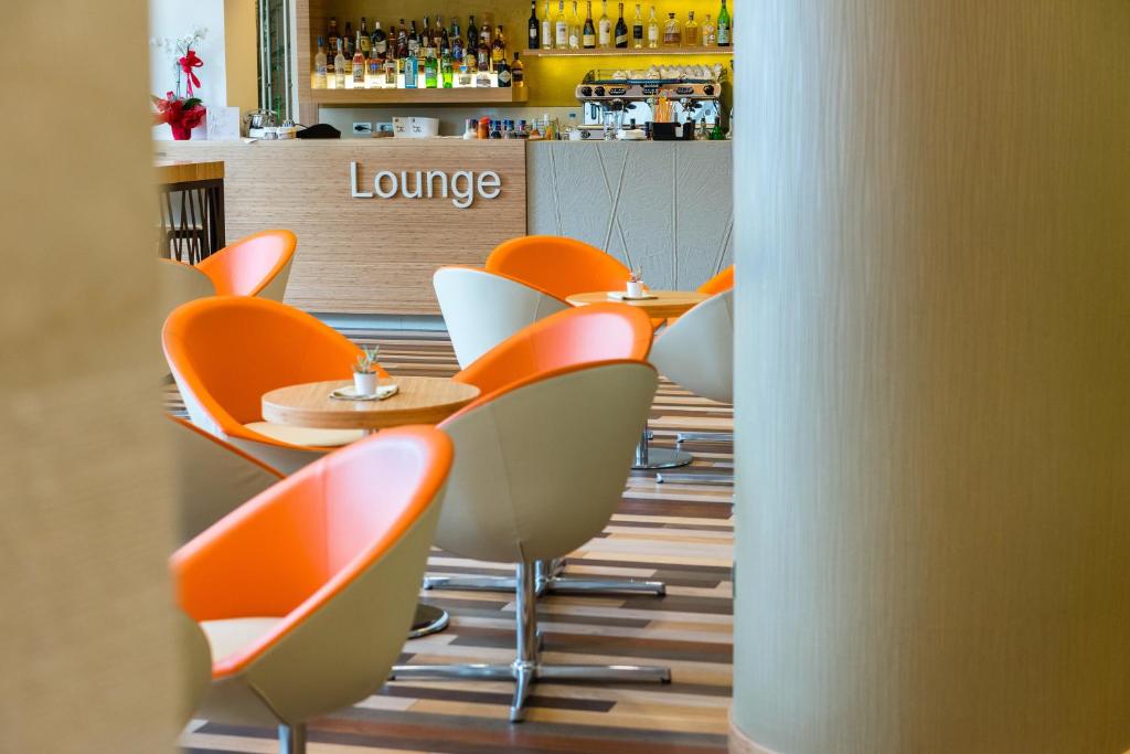 a row of chairs and tables in a restaurant at Laguna Park Hotel 4Superior in Bibione
