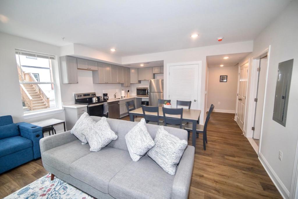 a living room with a couch and a kitchen at The Elise :Home Away From Home in Washington, D.C.