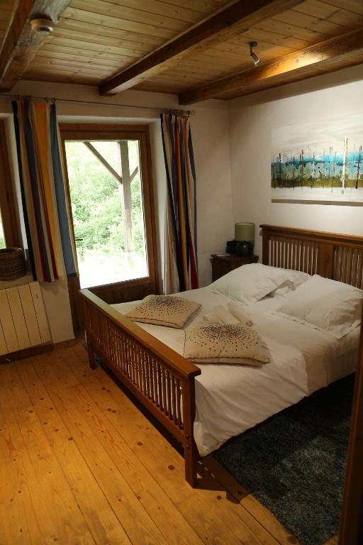 a bedroom with a large bed and a window at CHALET ELISTHUR in Saint-Jean-d&#39;Aulps