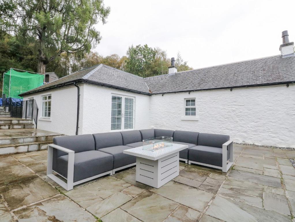 a patio with a couch and a table at Heatherbank in Garelochhead