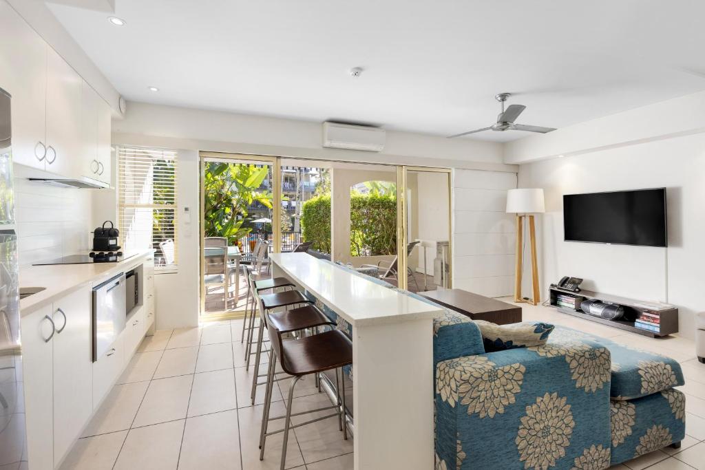 a kitchen and living room with a couch and a table at French Quarter Apartment 116, Noosa Heads in Noosa Heads