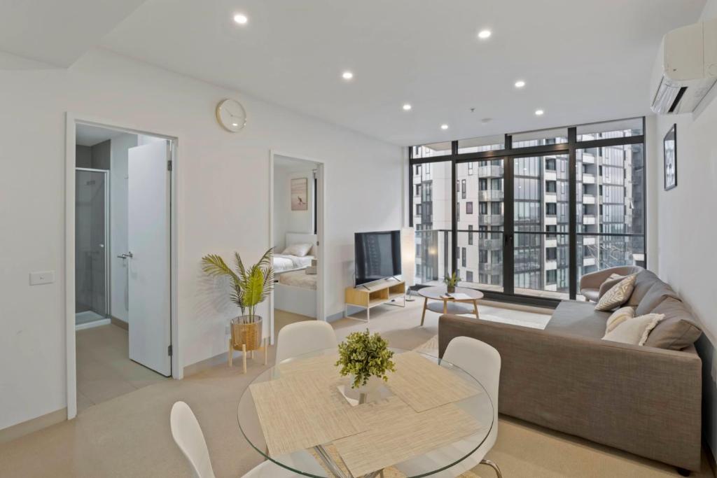 a living room with a couch and a table at Southbank Apartment with Skyline View: 5-Min Walk to CROWN Casino in Melbourne