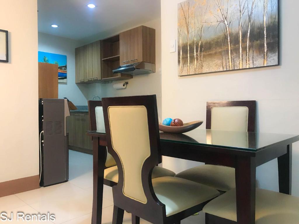 een eetkamer met een tafel en 2 stoelen bij 2 Bedroom Condo @ Midpoint Residences w/ City View in Mandaue-stad