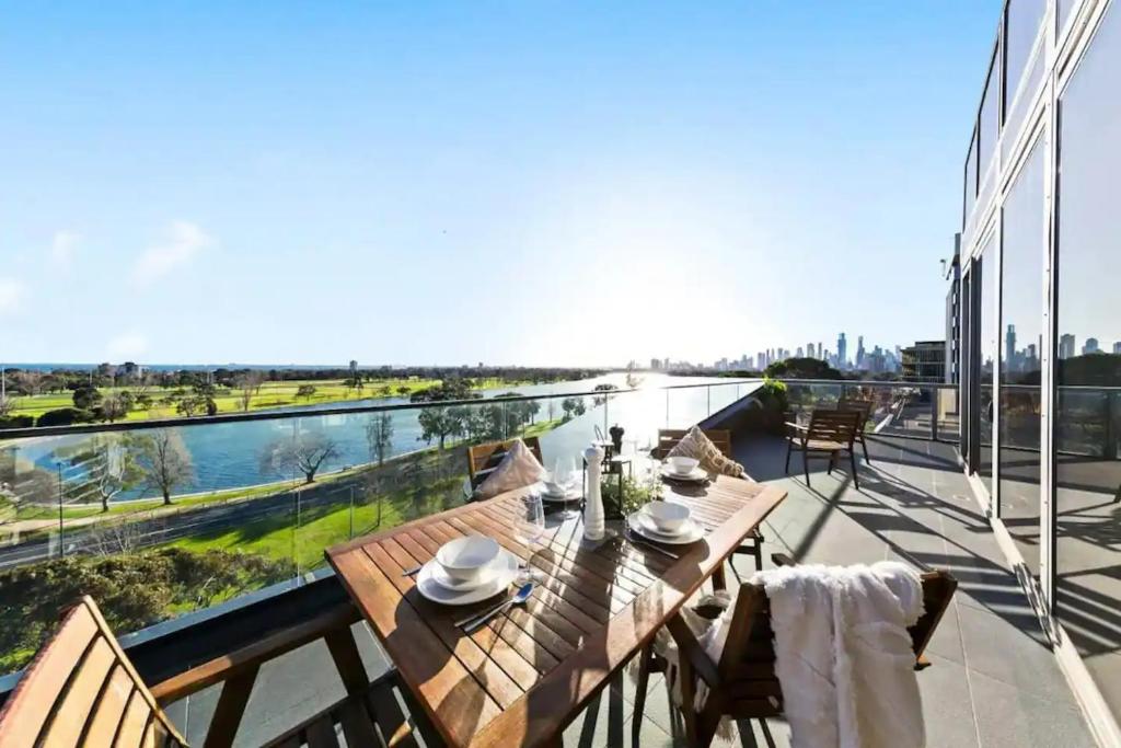 a patio with a table and chairs on a balcony at New listing! Amazing Park River View Luxury 3B2B in Melbourne