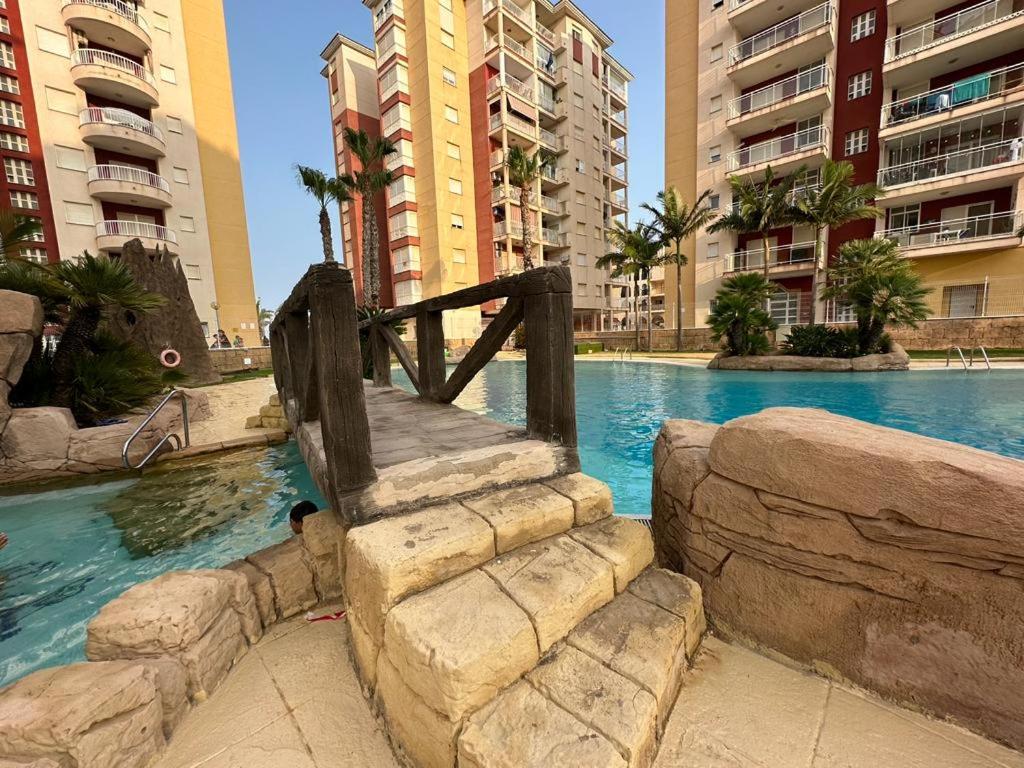 una piscina en una ciudad con edificios altos en Carla II View Apartment, en La Manga del Mar Menor