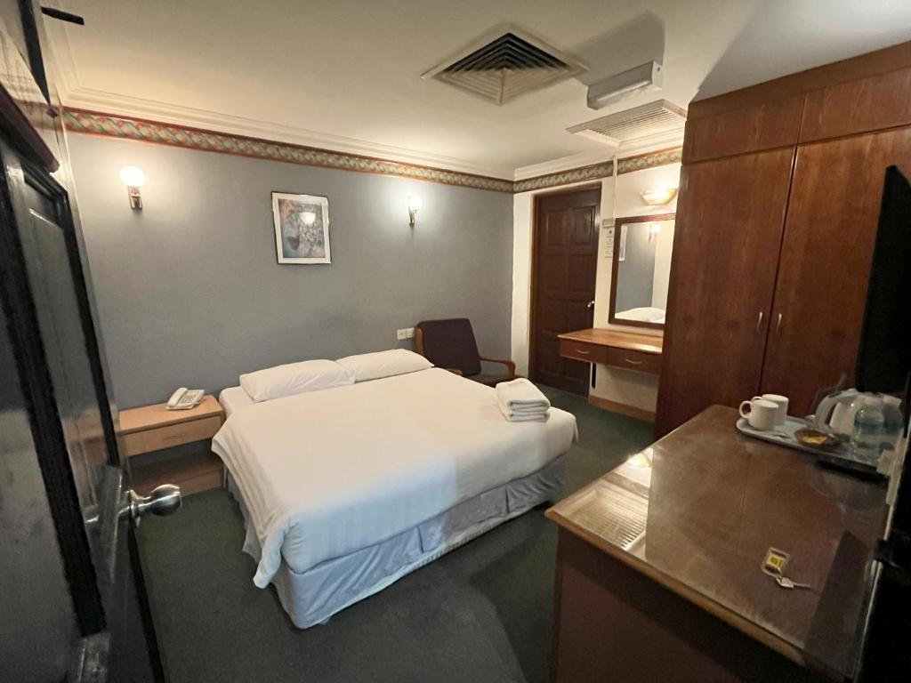 Postel nebo postele na pokoji v ubytování Fair Park Hotel