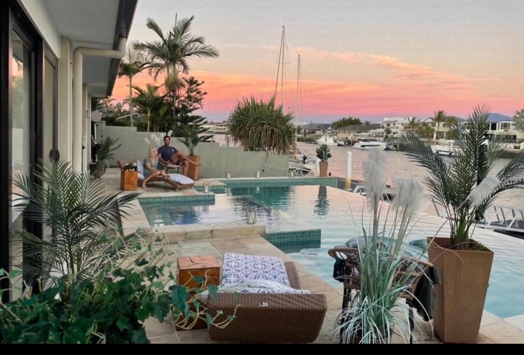 a view of a swimming pool with people sitting on a balcony at Bella Vista Bed and Breakfast of Raby Bay in Cleveland